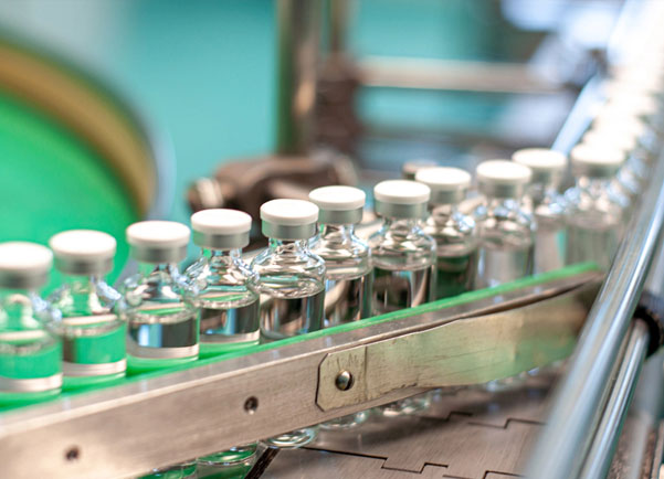 A row of vials on an assembly line
